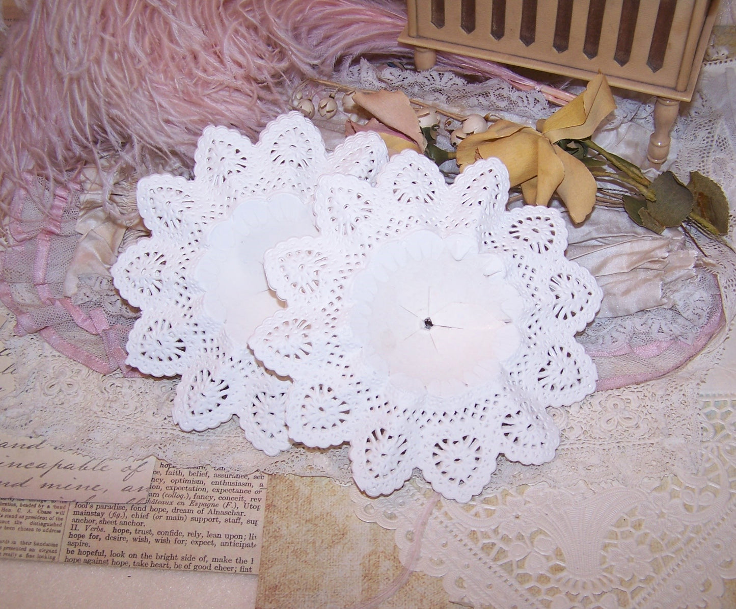 Set of 10 unused white bouquet holders. Measuring 5" across, the holders are made of white paper lace. Made in Germany.