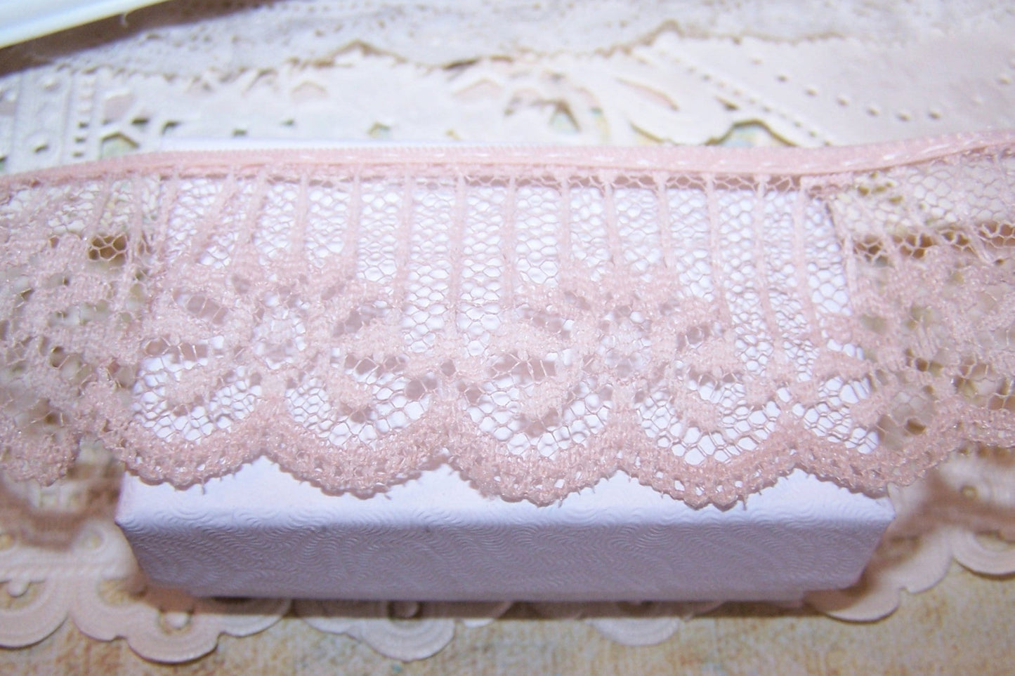 Custom dyed and ordered by me back in the 1990s, I can offer up to 50 yards of what the maker called "tea dyed" lace. Width is 1.5". Sold in lots of 5 yards,