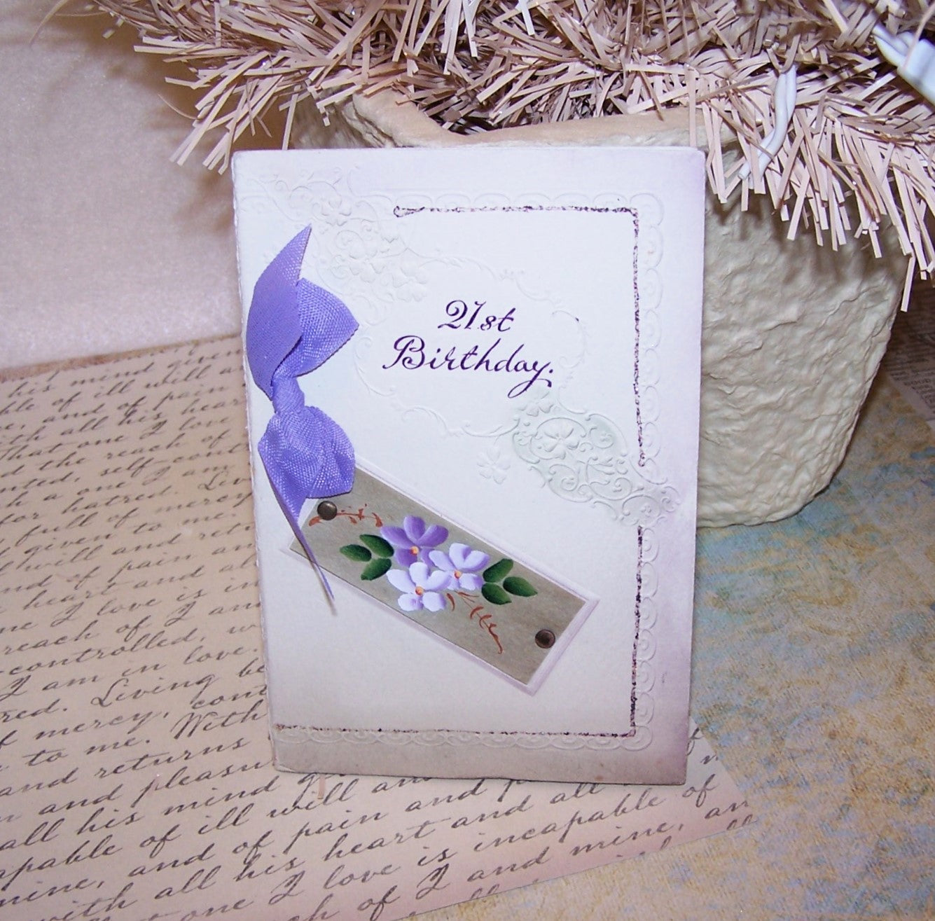 Made in England, an upcycled unused 21st Birthday card that can be gifted once again. Colors of cream, gold with lavender ribbon and a handpainted floral front.