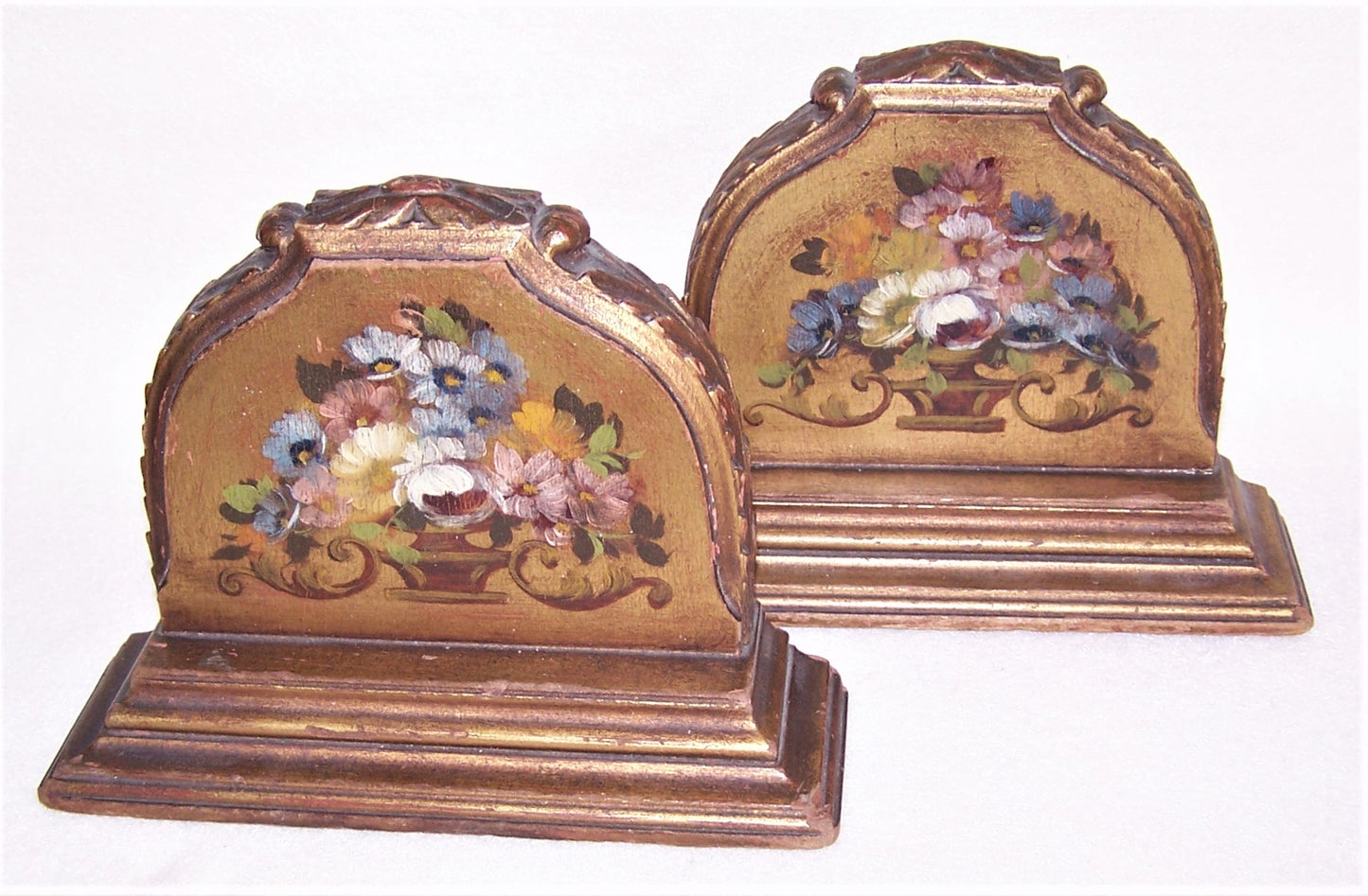 A pair of Art Deco era handpainted bookends in an elegant romantic shabby chic style. The front of each has a handpainted design of flowers in a vase.