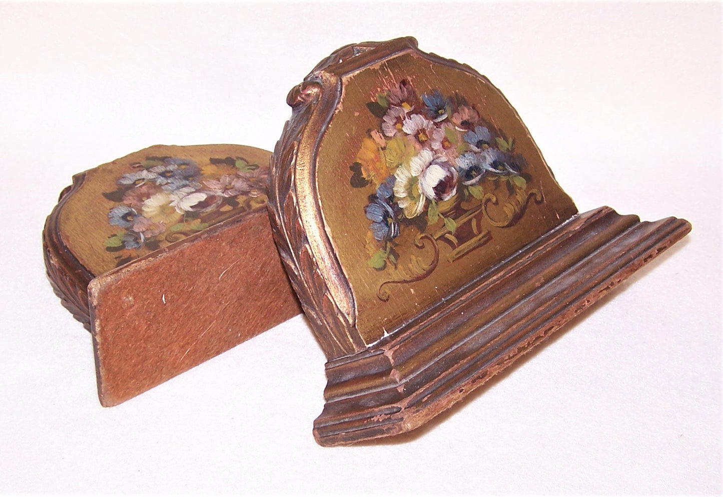 A pair of Art Deco era handpainted bookends in an elegant romantic shabby chic style. The front of each has a handpainted design of flowers in a vase.
