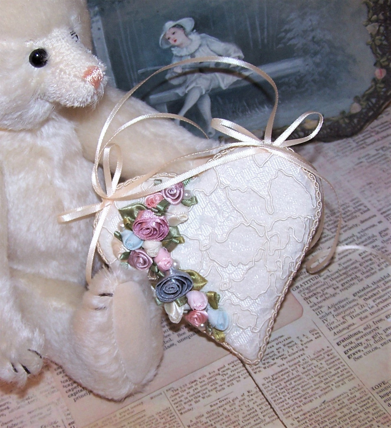 Cream brocade heart ornament/decoration for any occasion. Overlaid with lace, the side front is decorated with ribbon roses by Offray in blue, pink and mauve.