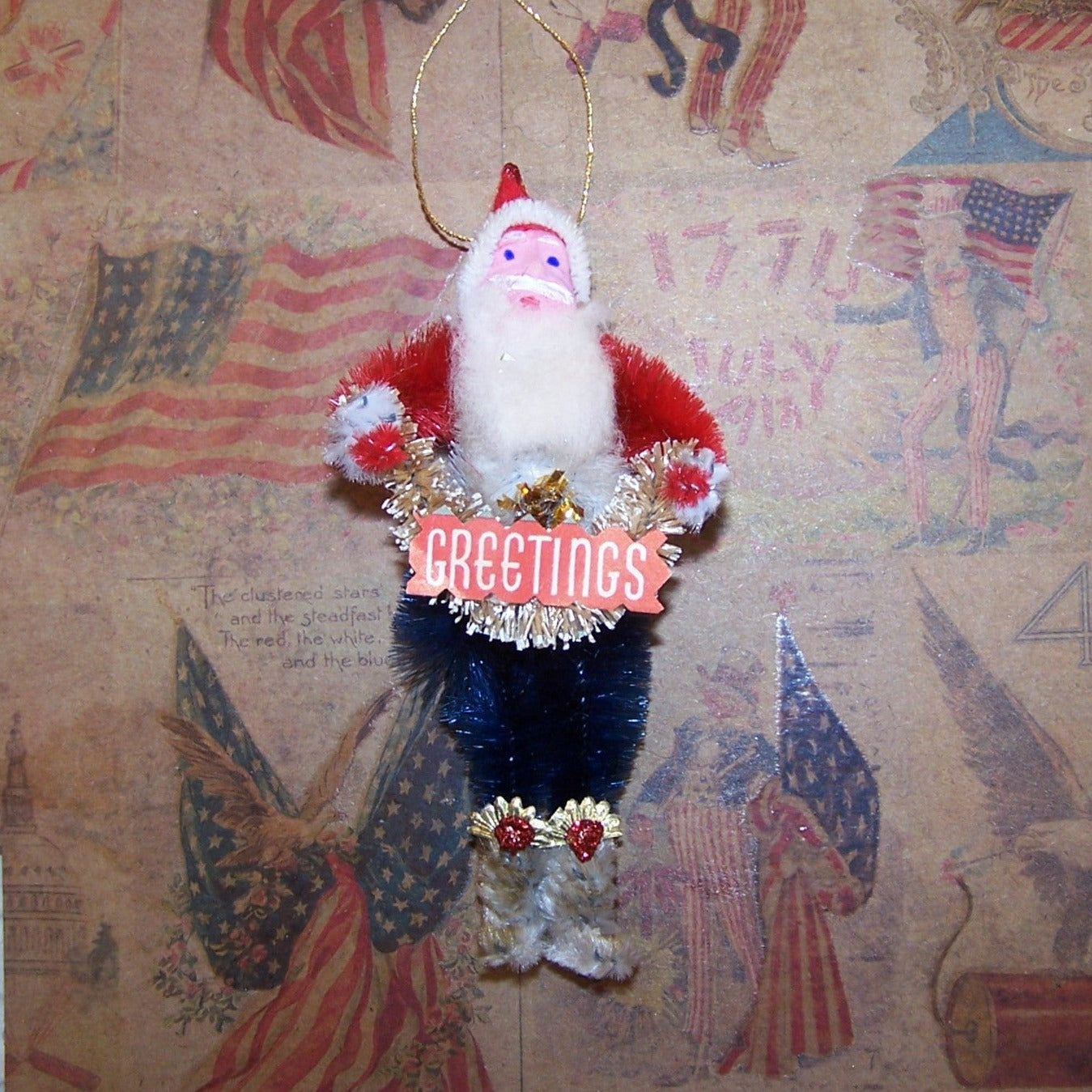 Vintage-style Santa Claus ornament with 'Greetings' text on a decorative background.