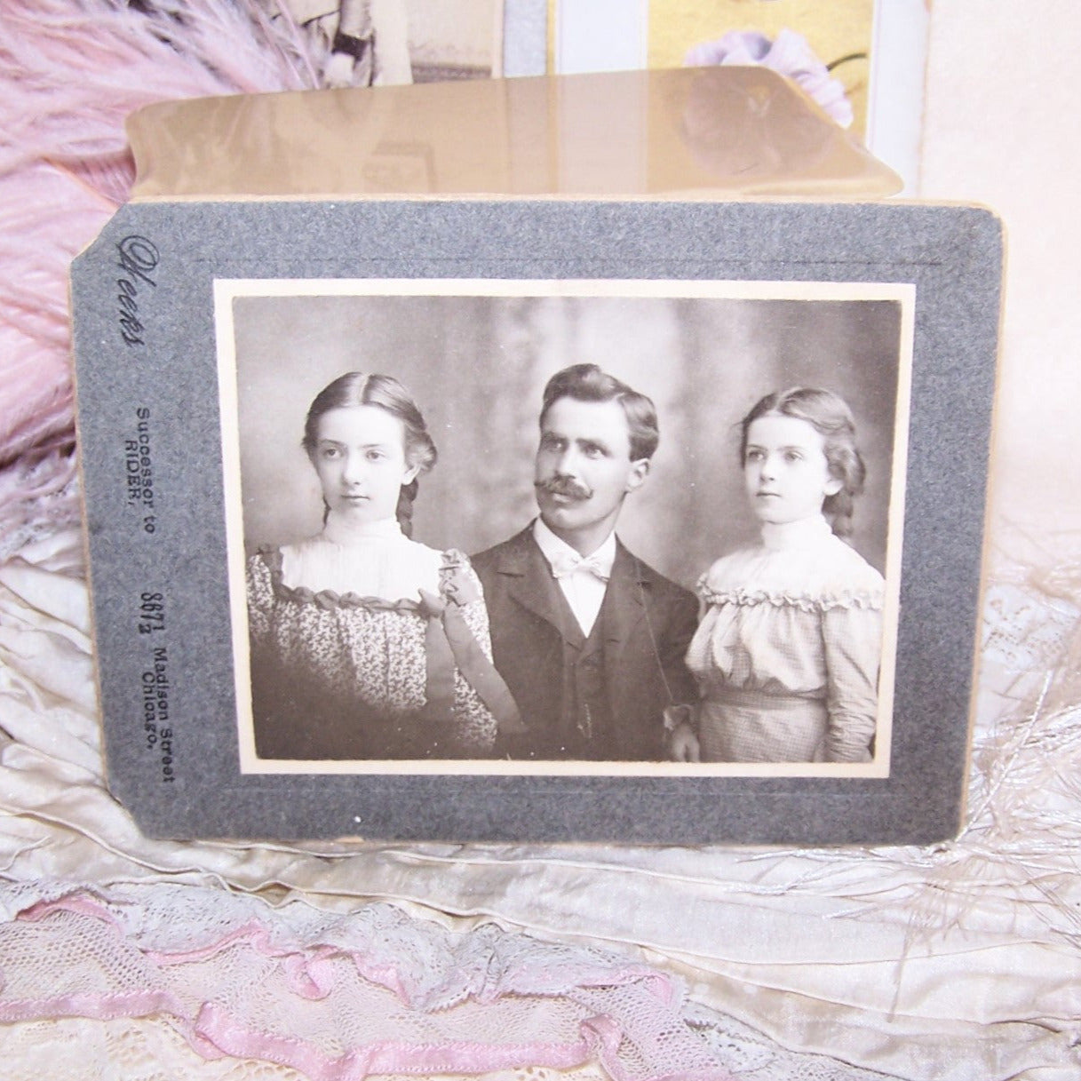 Antique black and white photograph of father (dapper gent with handlebar mustache) and his 2 daughters. Chicago photographer called Weeks.