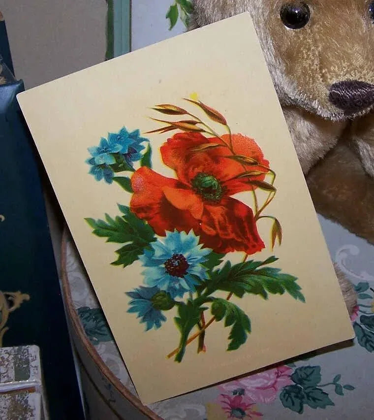 Antique Victorian C.1883 high gloss chromolithograph of a small floral spray - a red Poppy and blue Anemones. Size is 4-5/8" x 7". Condition is very nice.