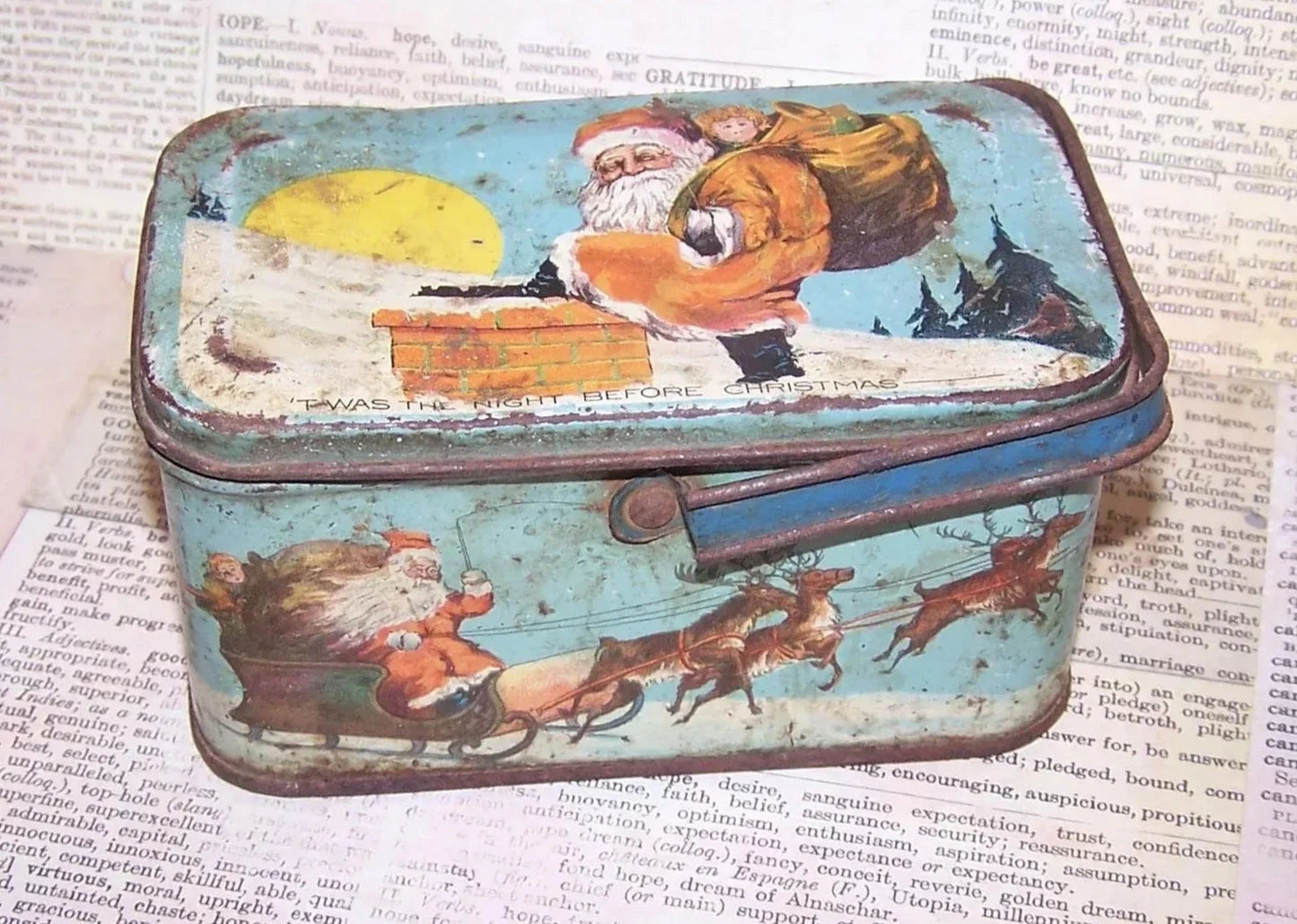 Art Deco lithographed tin Christmas box by Tindeco. With handle, the box has Santa Claus graphics touching on the "Twas the Night Before Christmas" poem.