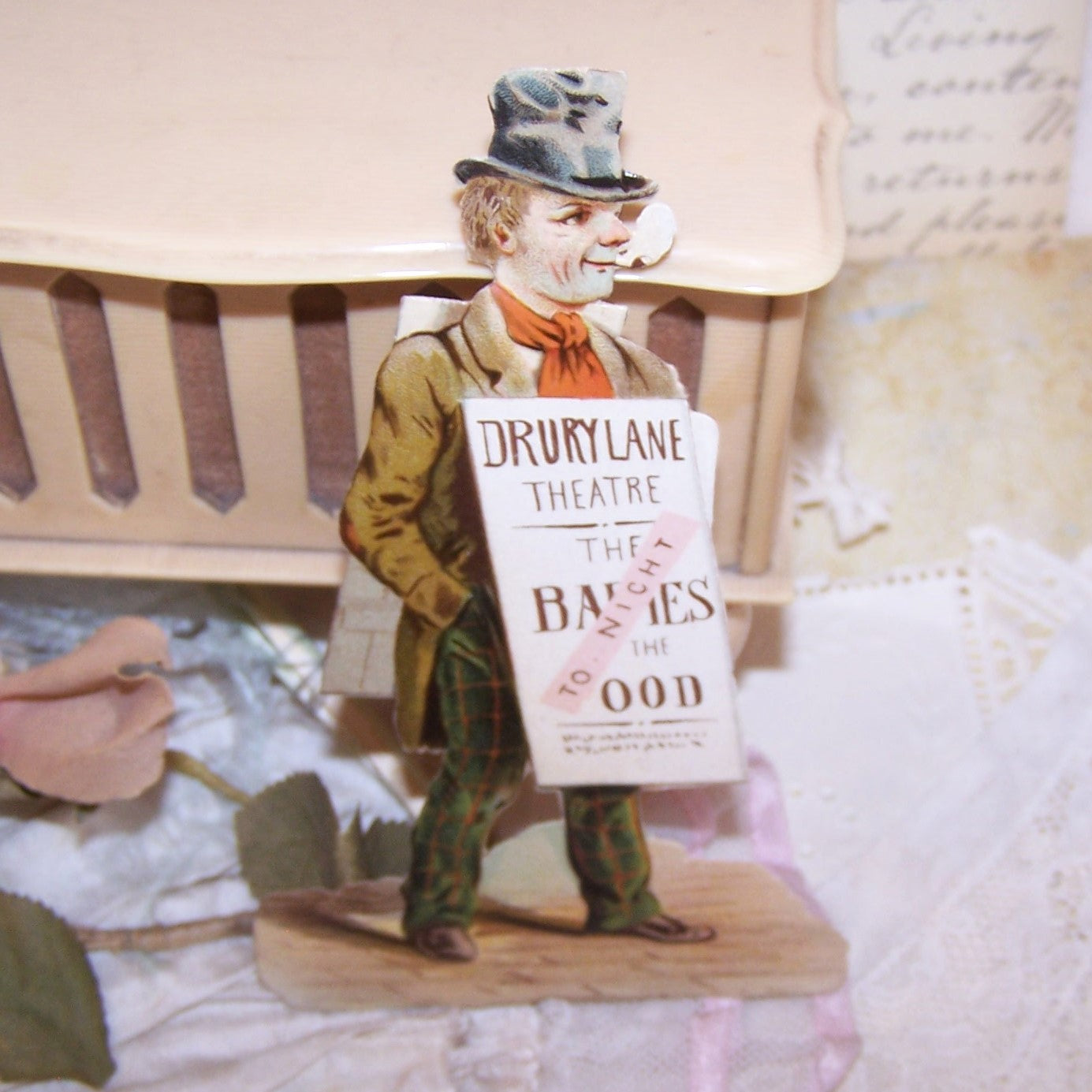 Dating to the late 1890s or so, here's a pristine Antique Victorian die cut - a man carrying a sandwich board advertising a play at the Drury Lane Theatre, London England. Size of the piece is 4-3/4" x 3" approx. Again, pristine - no paper loss, breaks, discoloration, etc.