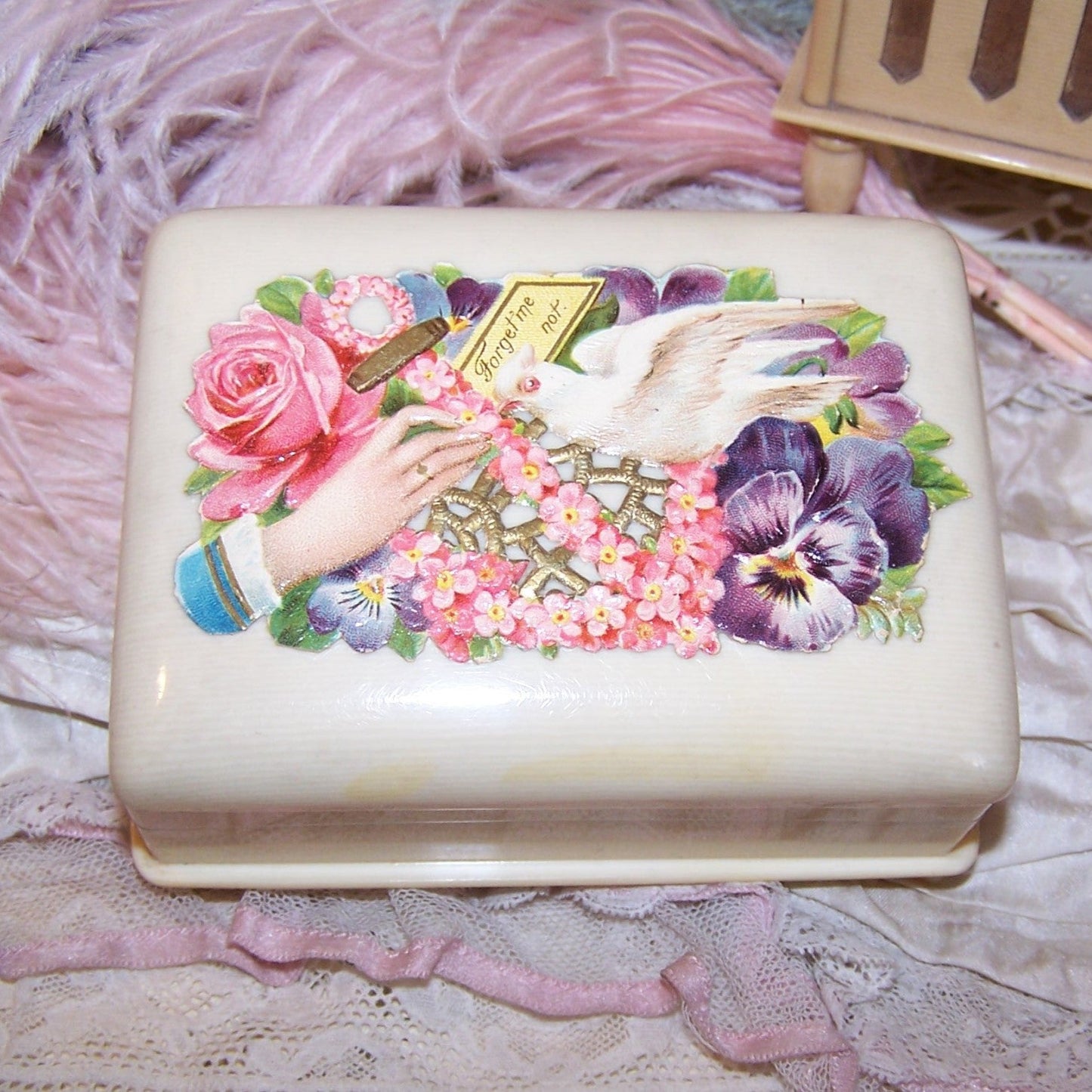 Art Deco celluloid jewelry box! Inside reveals purple velvet inside with recessed area for chains, right side has 3 slots for rings. 4" x 3" with 1-3/4" height.