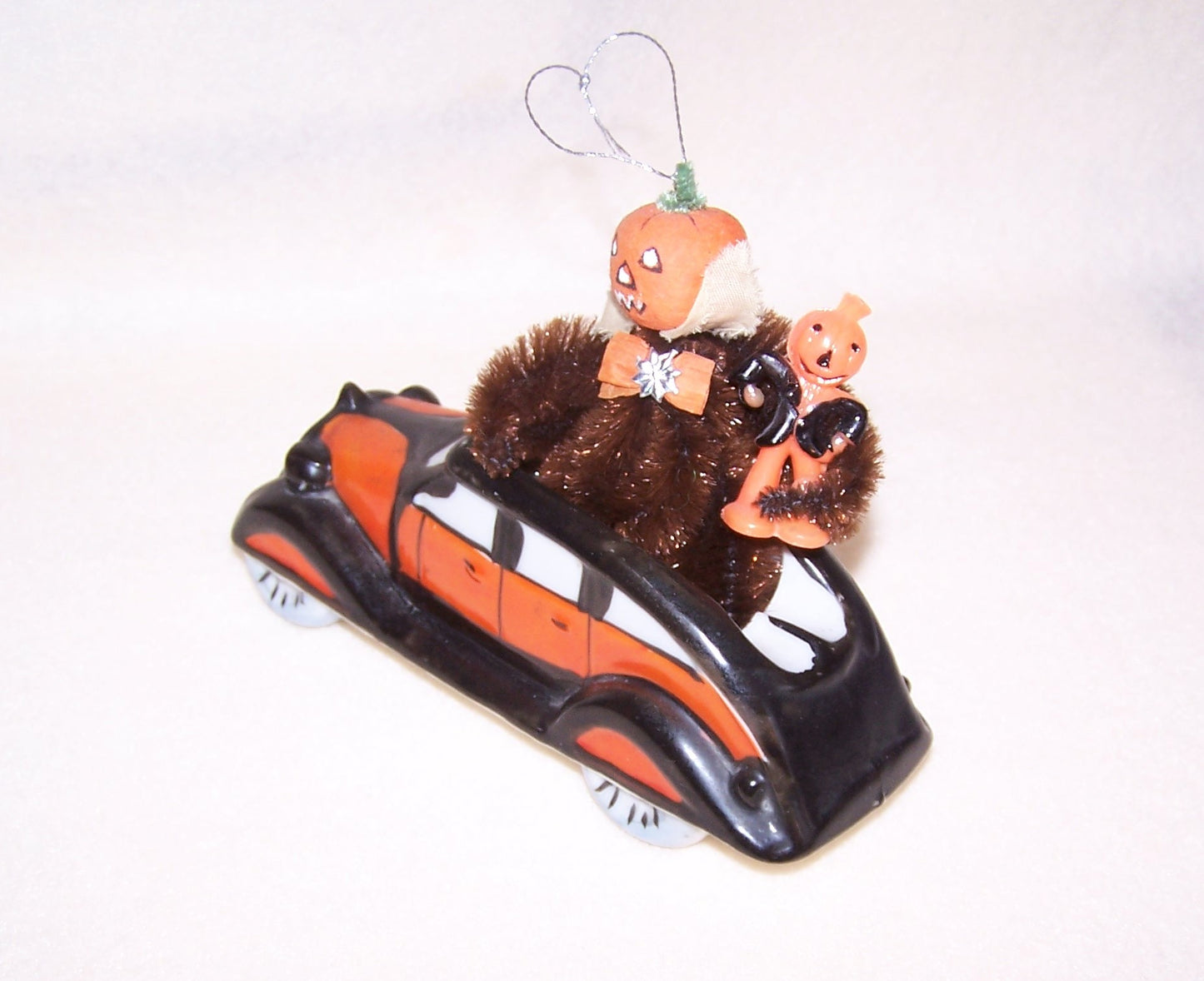 Art Deco ceramic roadster from Japan! In Halloween colors, it was made to hold a pack of cigarettes. Perfect vehicle for a Halloween collectible. 6" x 2-1/8".