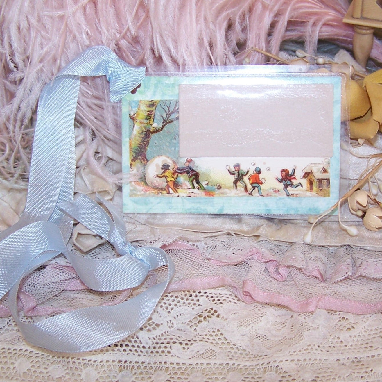 Victorian Revival mixed media reuseable gift tag - package tie. Cardstock is overlaid with a calling card displaying an image of Children Playing in the Snow.