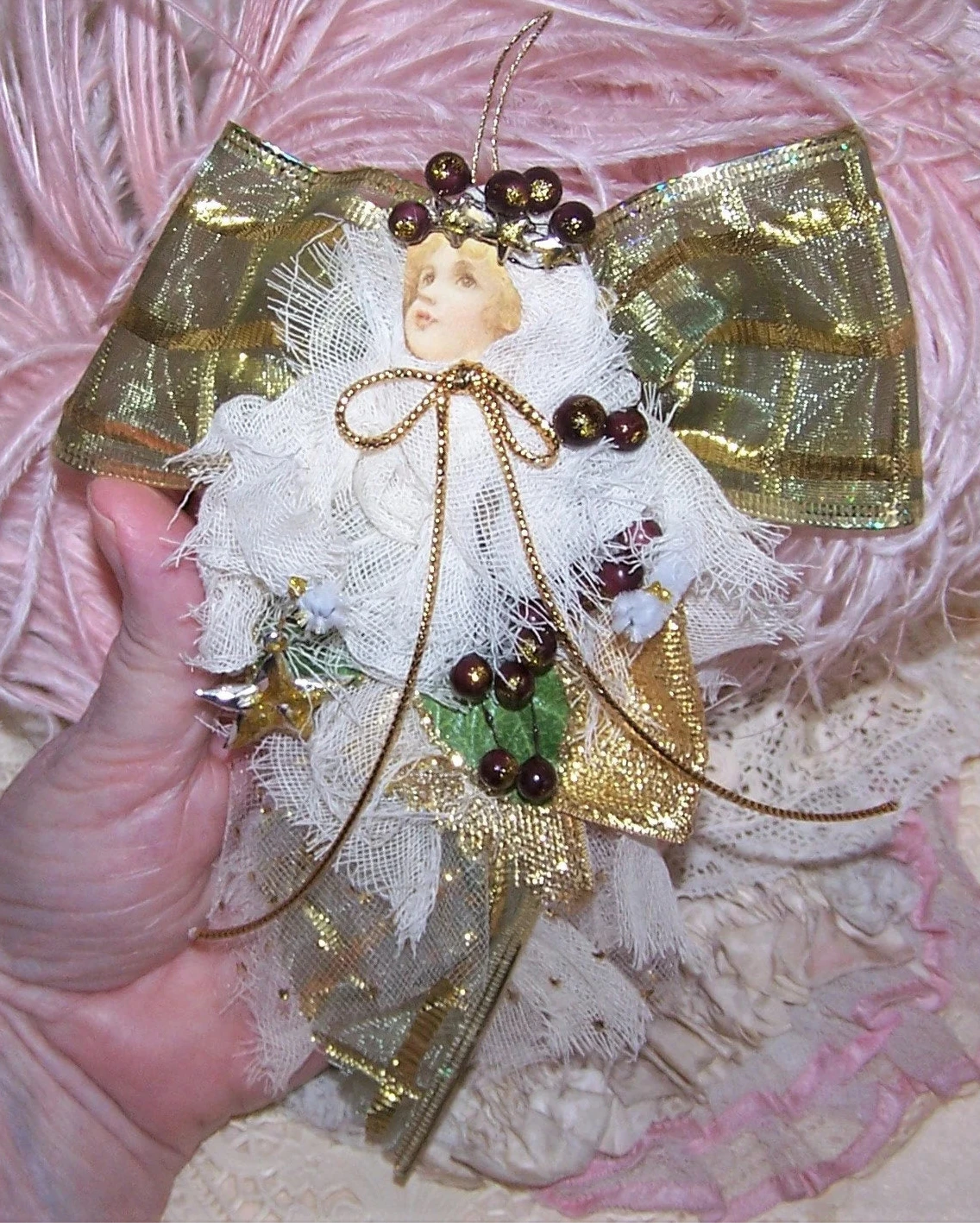 Mixed media Christmas ornament of a Guardian Angel. Covered in cream gauze with olive green/gold wings, my lady carries a gold star and berries. One of a Kind!