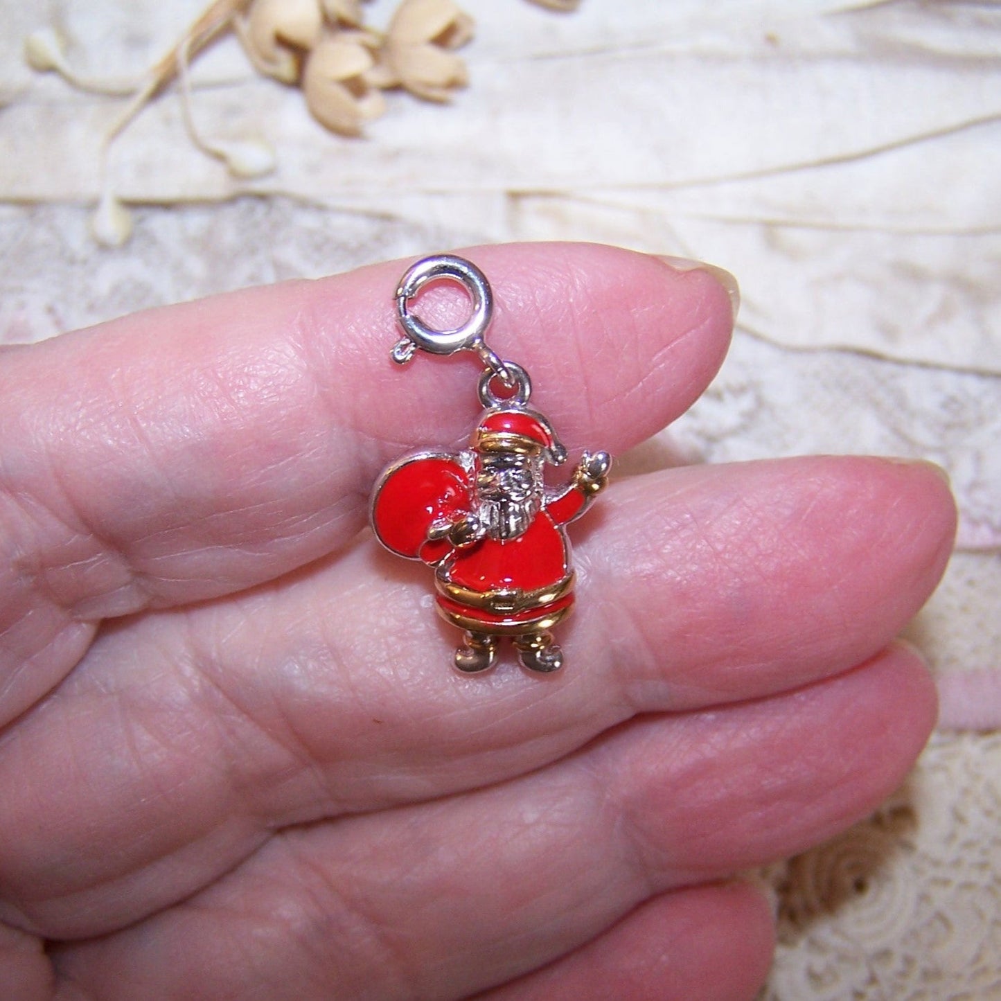 D'Joy Sterling Silver and cold enamel clip on charm of Santa Claus. Santa measures about 3/4" high and weighs 4.9 grams. Condition is very good.