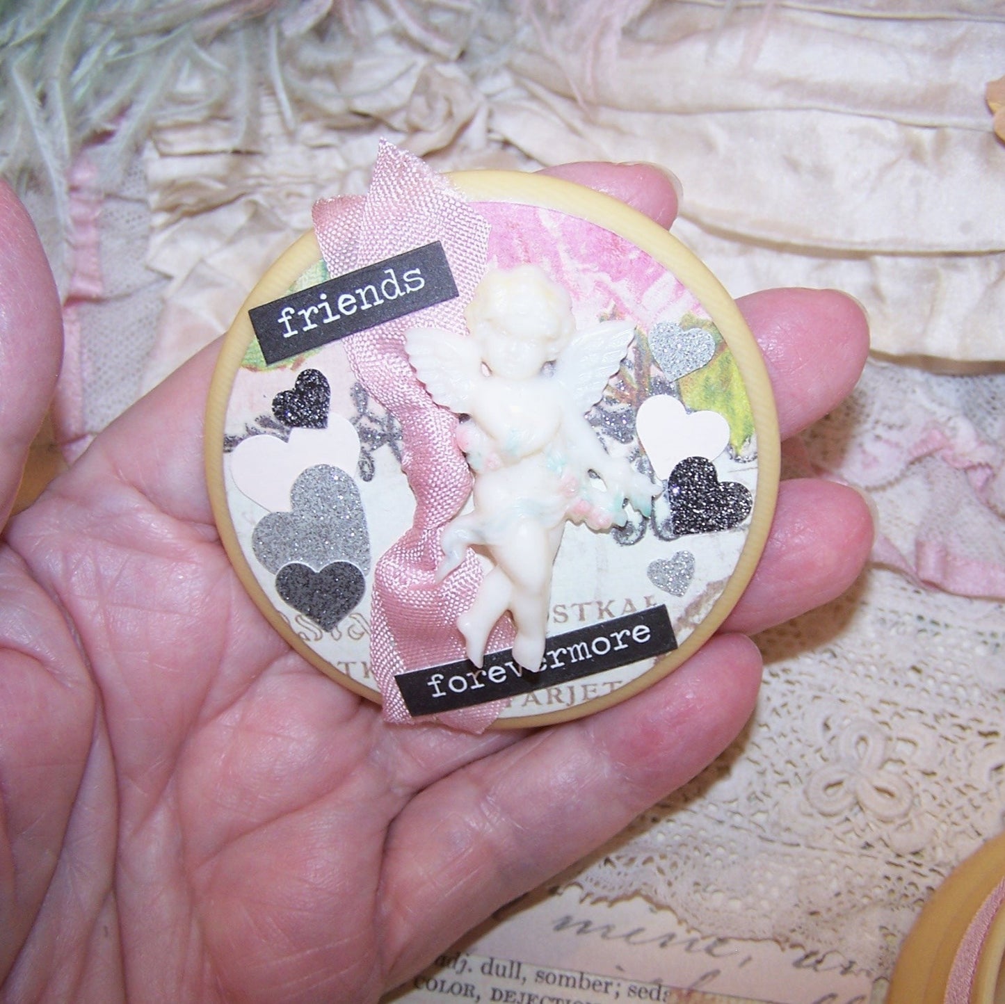OOAK repurposed Art Deco celluloid powder container - twist lid. With a bit of pink frippery, silver hearts and more, the sentiment is FRIENDS FOREVERMORE.