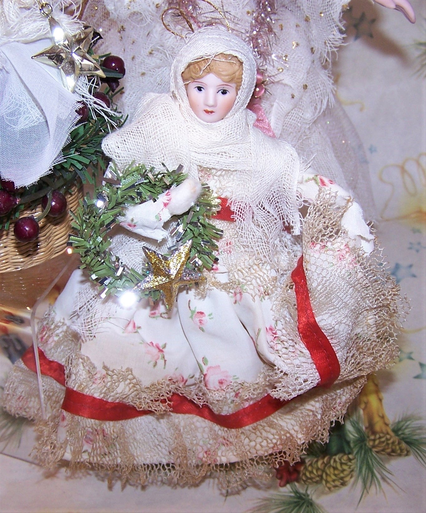 One of a kind handcrafted holiday christmas decoration creauted with vintage components - old lace, ribbon and fabric. The head of the doll is porcelain while the body is spun cotton. The young girl carries a green holiday wreath in one arm, adorned with a gold star. Size is about 6" high.