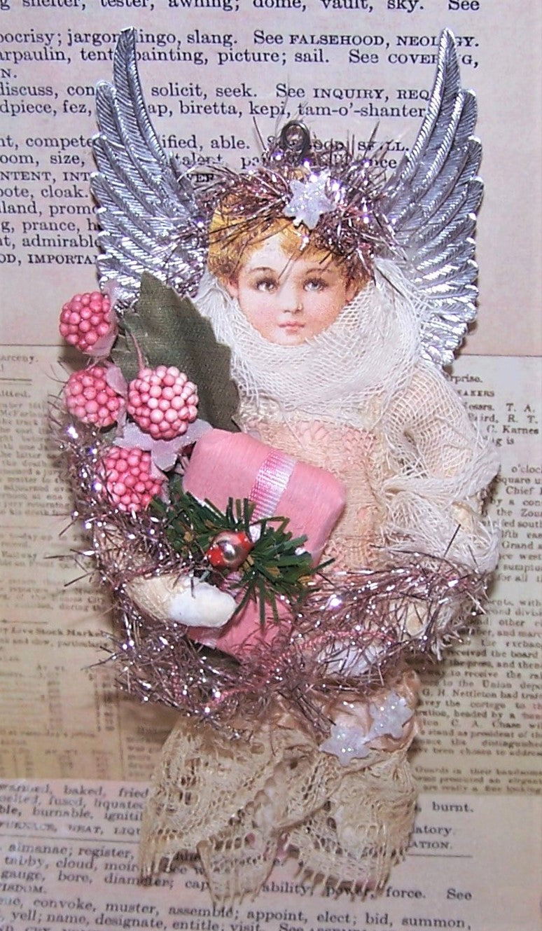 Handmade spun cotton Guardian Angel ornament in a Victorian Revival manner. The lady carries a spray of berries and a pink paper package. One of a Kind.