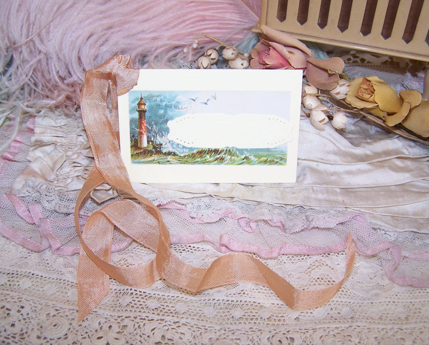 Antique Victorian mixed media gift tag/package decoration. Front of depicts the ocean and lighthouse; sentiment is WITH LOVE AND FOND WISHES. Reverse is blank.