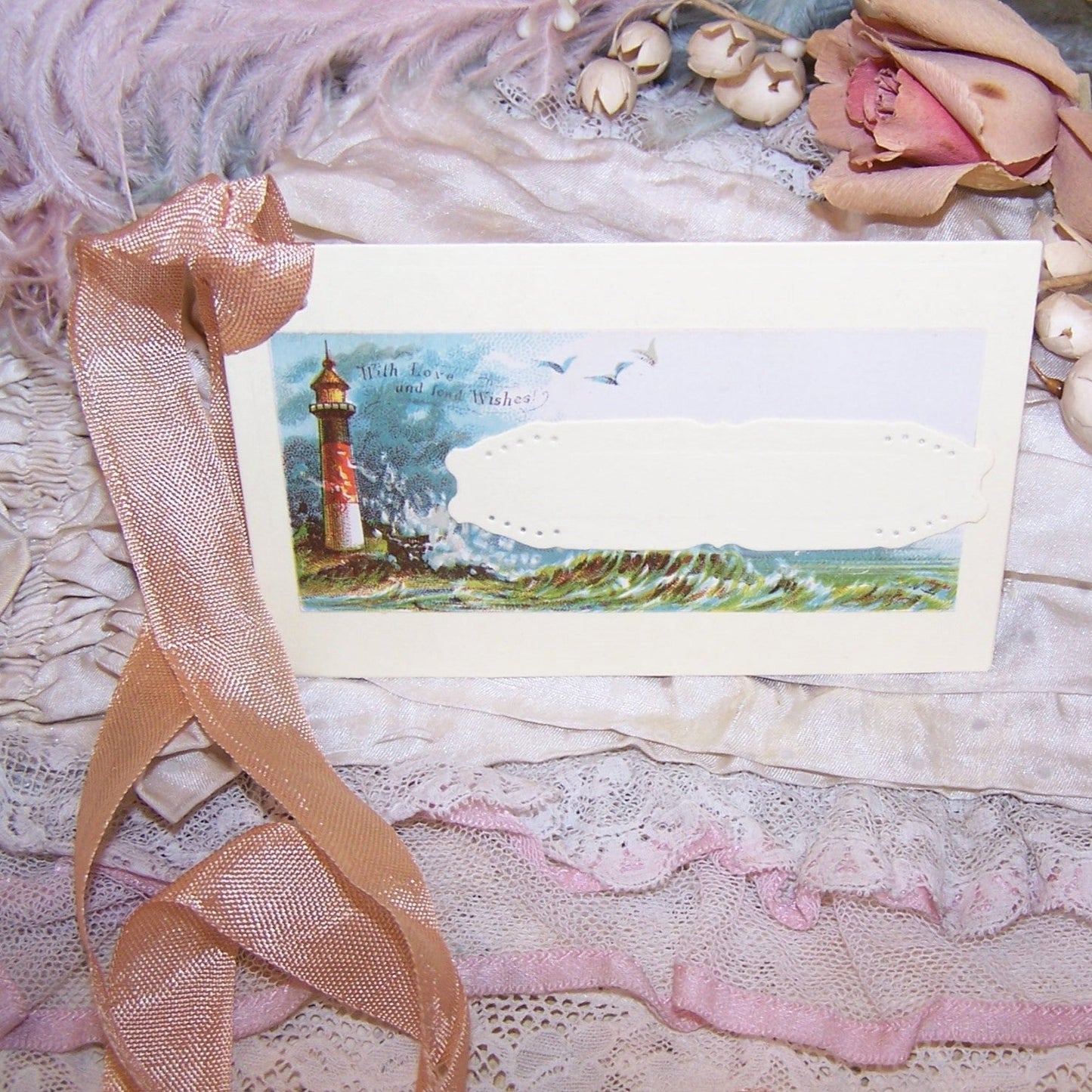 Antique Victorian mixed media gift tag/package decoration. Front of depicts the ocean and lighthouse; sentiment is WITH LOVE AND FOND WISHES. Reverse is blank.