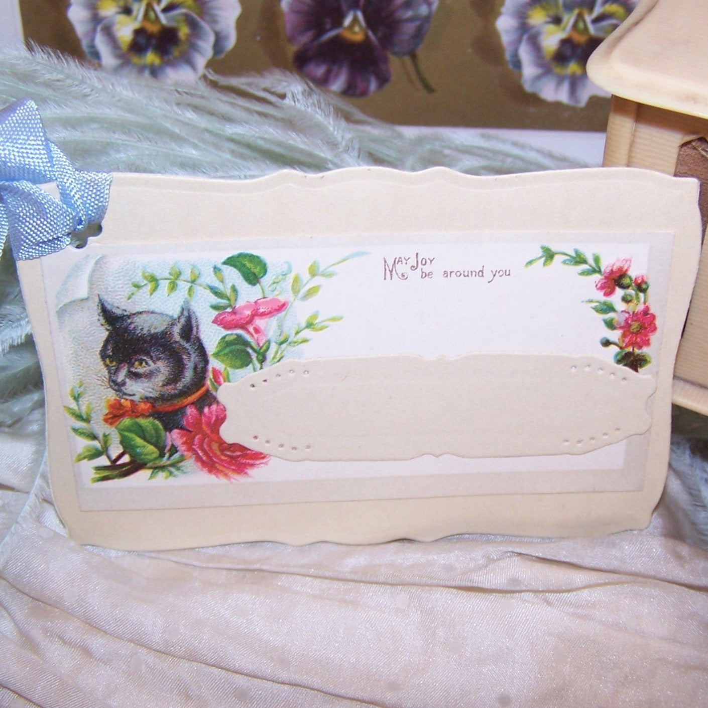 ONE OF A KIND handcrafted gift tag / paper ornament featuring a Cat and blue rayon ribbon. Sentiment is MAY JOY BE AROUND YOU. Can only be used once!