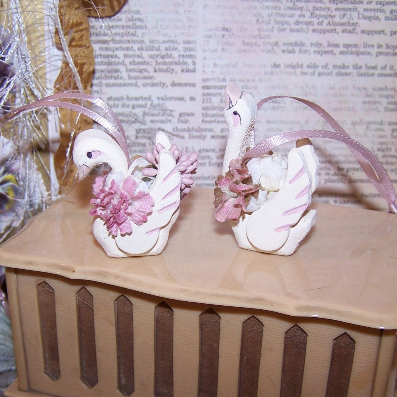 2 wood swan ornaments in colors of cream / dusty mauve. 2 designs, you get 1 of each. Terrific wedding favors or bridal shower ornaments. Swans mate for life!