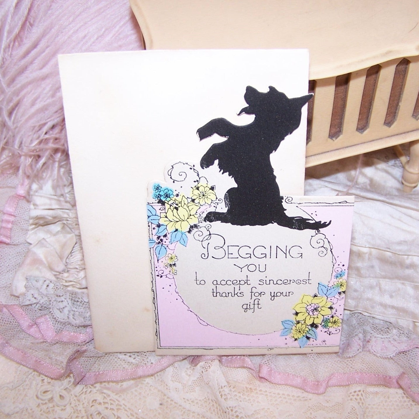 "Begging You to Accept Sincerest Thanks for Your Gift" is the sentiment of this unused card.  Graphics to the front include a black terrier and sprays of flowers.