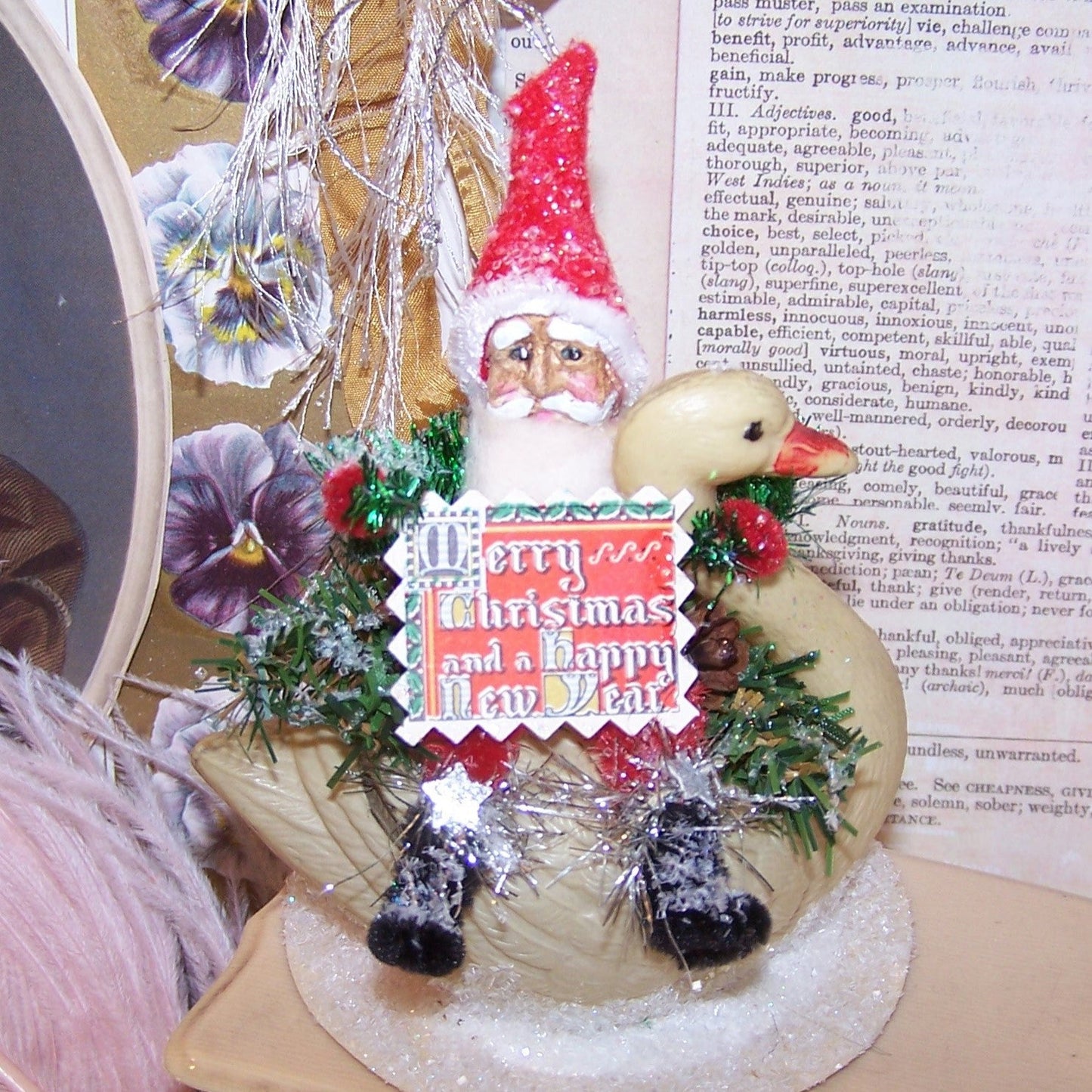 OOAK Chenille Santa Claus riding an upcycled Art Deco era celluloid swan. Sentiment is "Merry Christmas and a Happy New Year." 4-3/4" x 3-1/2". Lightweight.