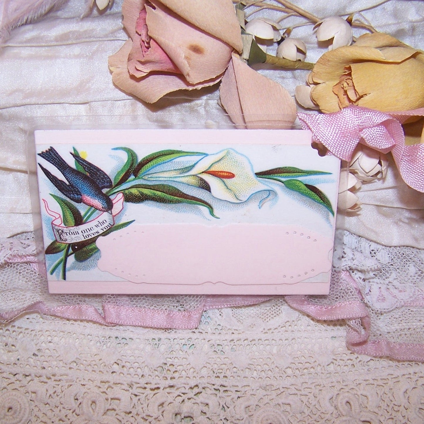 Antique Victorian mixed media re-useable gift tag. Calling Card displays a calla lily and bird carrying a banner that reads "FROM ONE WHO LOVES YOU."