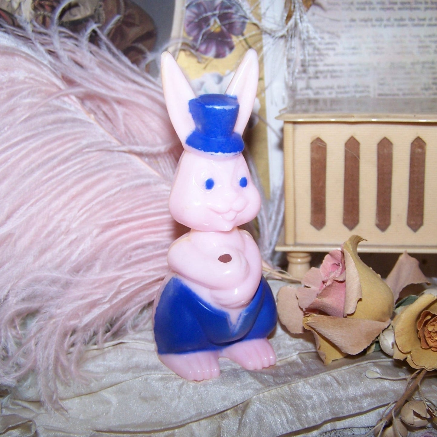 Vintage pink / blue hard plastic Easter Bunny Rabbit candy container. Front opening for a sucker; at the back, a pocket for a note or small bar of chocolate.