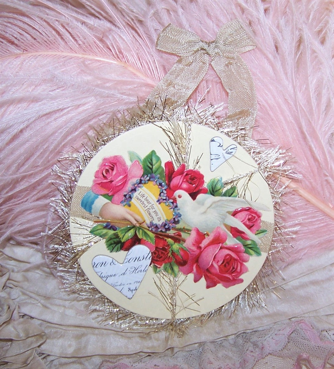 A Mixed Media Decoration with an Antique Die Cut displaying a dove, lots of flowers and the phrase LIFE BEAR FOR YOU ITS SWEETEST FLOWERS. Blank back.