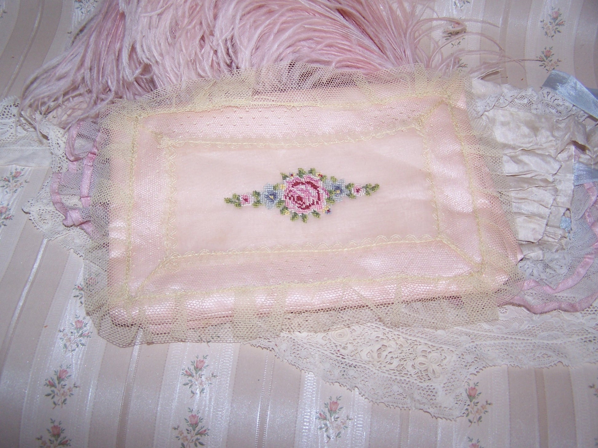 Small Art Deco hanky holder of pale pink satin covered with a lace overlay and then hand embroidered with a single pink rose and blue forget-me-nots.
