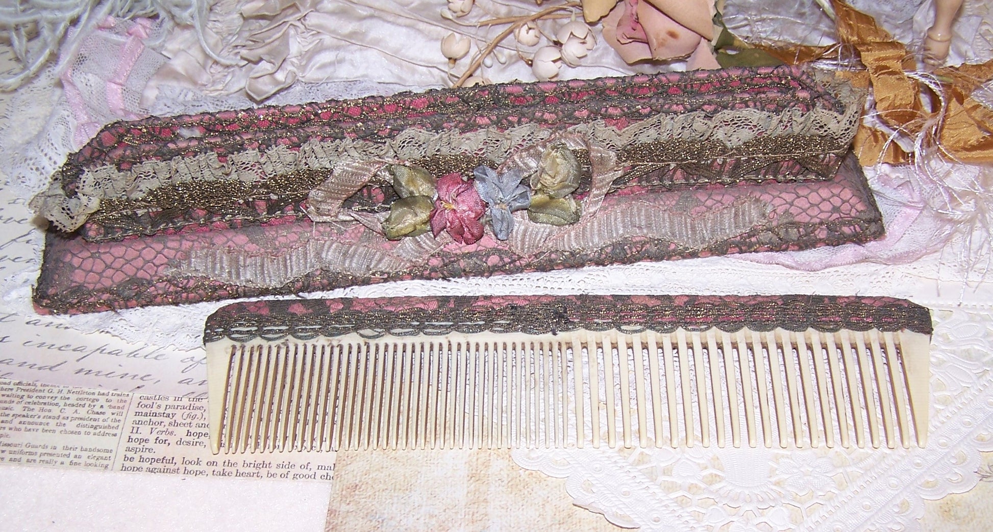 Art Deco Boudoir Comb Holder with Celluloid Comb. Mauve fabric overlaid with gold lace; silver lace side trim. French ribbonwork further embellishes the piece. 