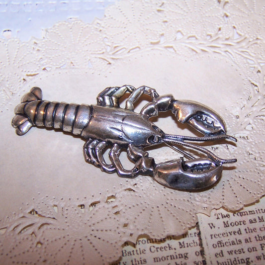 1960s Sterling Silver pin/brooch by Beau in the shape of a lobster.  Good strike to the design. Length is 2-1/4". Vintage patina to the silver.