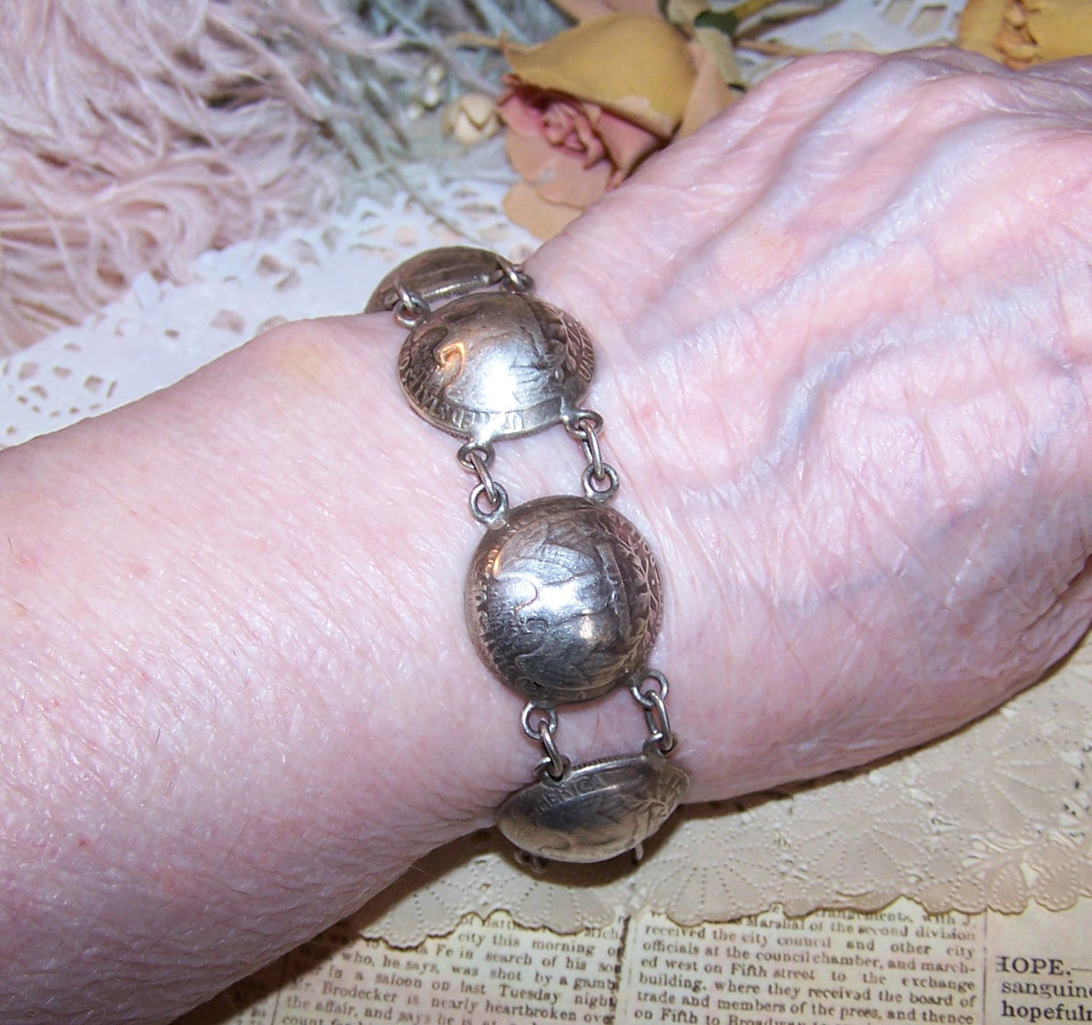 Handcrafted coin silver bracelet with American Quarters dated 1964. Pounded into a concave design, the design is akin to Southwestern jewelry.  7.75" long.  