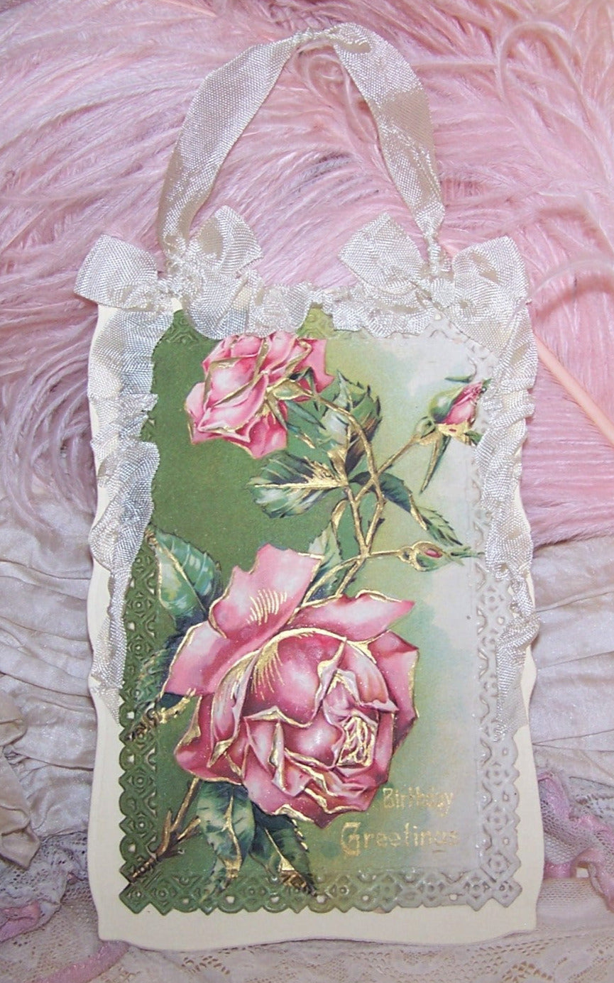 Repurposed Antique Postcard that displays pink roses along with the sentiment BIRTHDAY GREETINGS. Reverse is blank and has room to write your own message. 