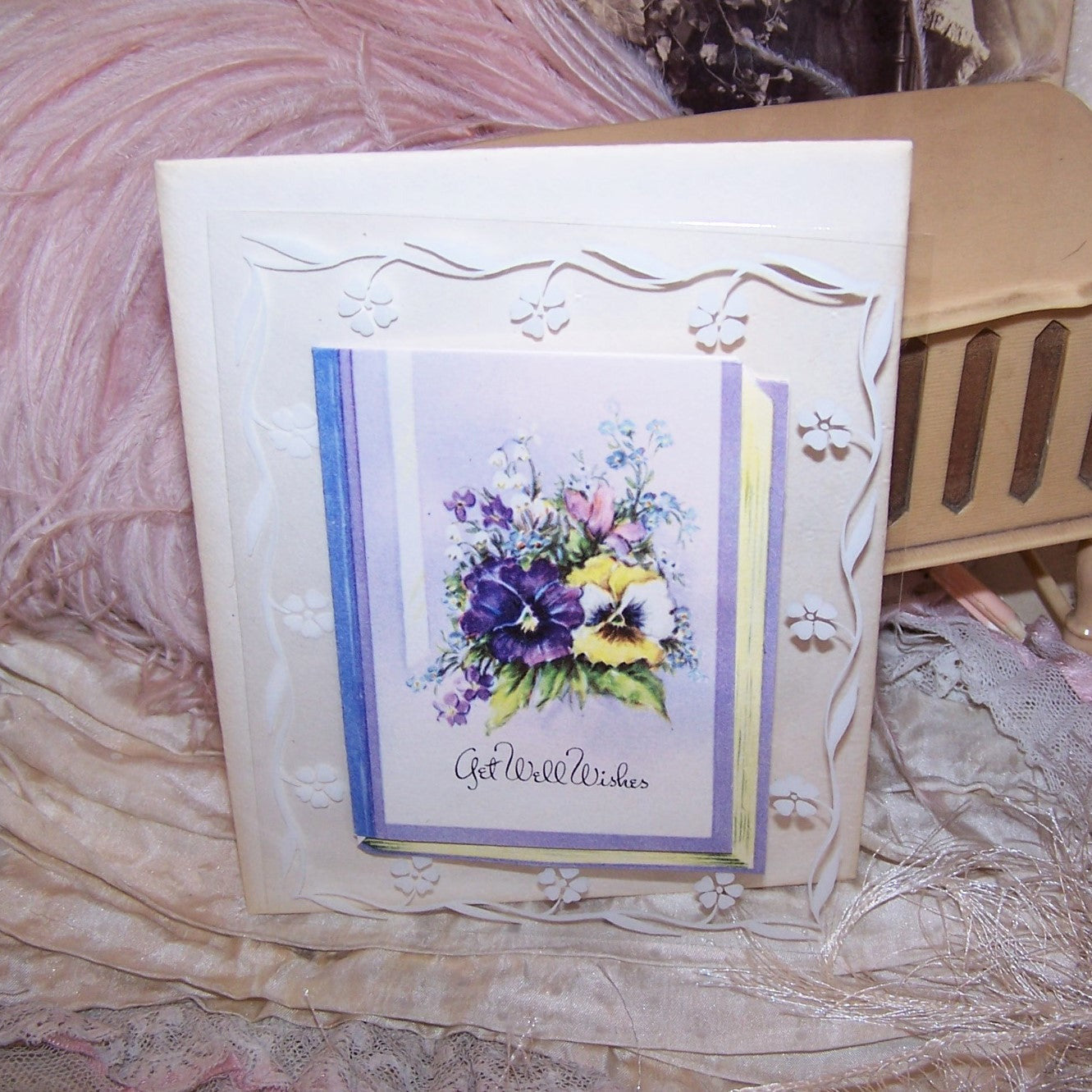 An unused 1950s Get Well Card. Featuring lovely graphics of flowers - Pansies, Lily of the Valley and more, the book-like card opens to reveal a small verse. 