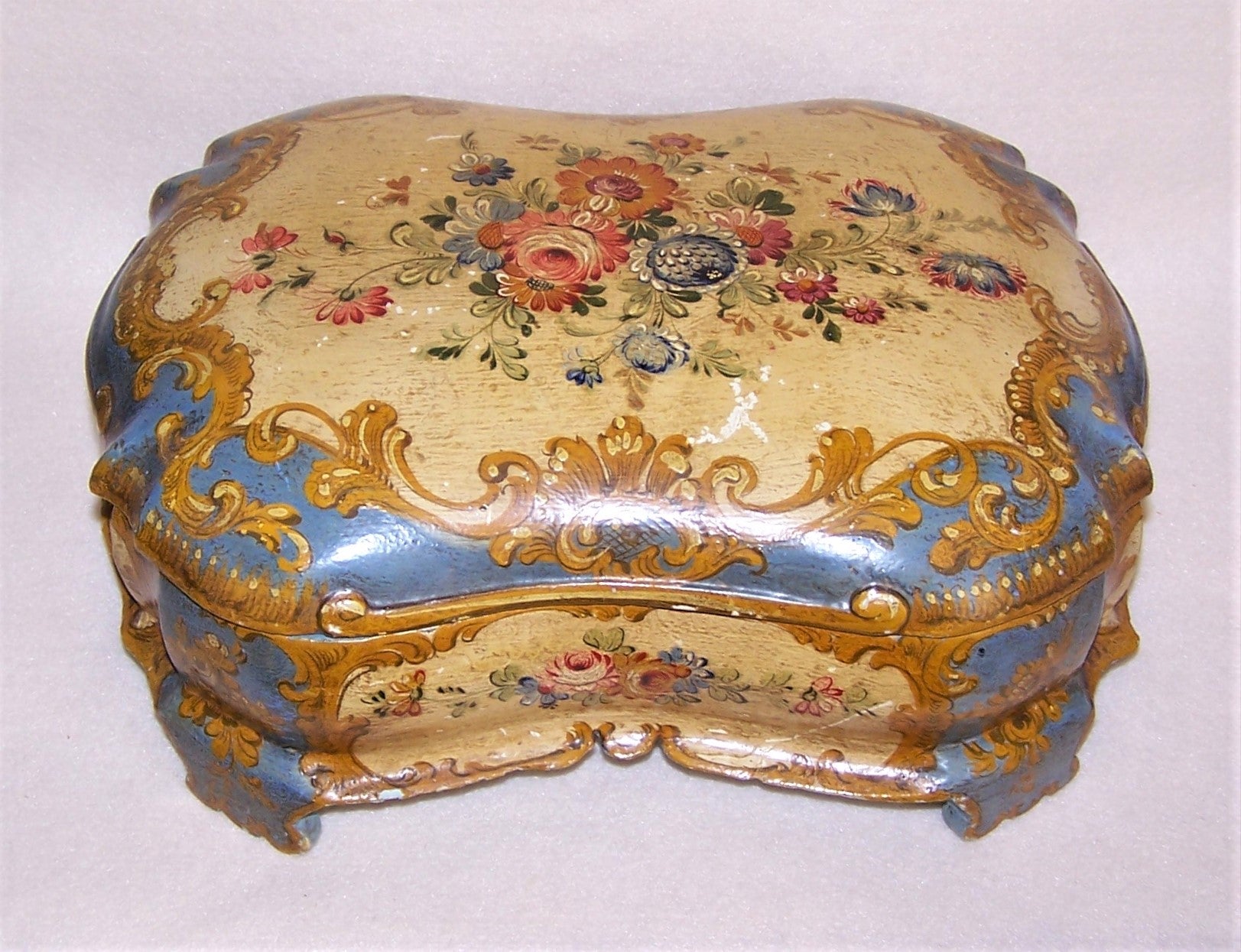 Large Italian Tole handpainted tabletop box.  Made of wood and painted in oils, the design is Shabby Chic floral.  Buttercream and French Blue coloring.  