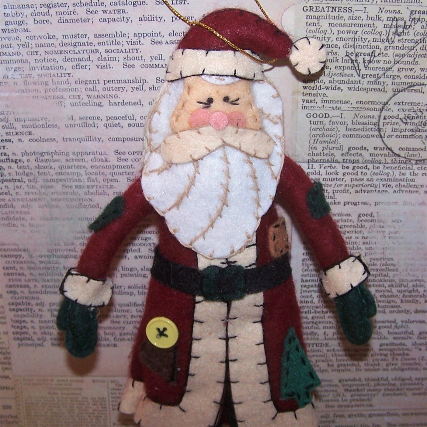 Handsewn felt 11" x 5" Santa Claus doll.  Blanket stitched.  Absolutely adorable with button accents and faux leather soled boots. Condition is excellent.