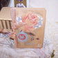 Christmas greeting card with an embossed celluloid cover of roses and 4 leaf clovers; the front sentiment is GREETINGS. Open the card to reveal a clean interior with a small Christmas poem. 
