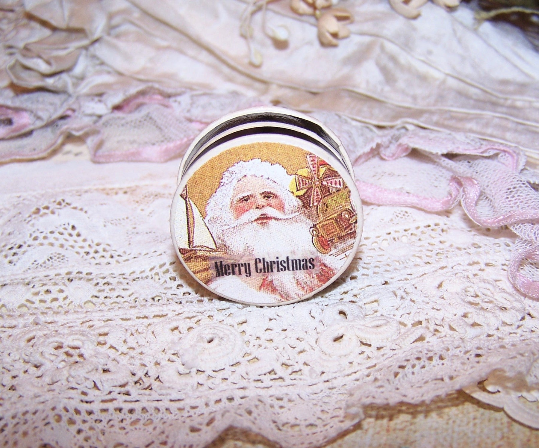Repurposed Antique French pharmacy pill box.  The lid bears an image of Santa Claus in golden tones. Sentiment on top is MERRY CHRISTMAS; nothing on the inside.