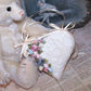 Cream brocade heart ornament/decoration for any occasion. Overlaid with lace, the side front is decorated with ribbon roses by Offray in blue, pink and mauve.