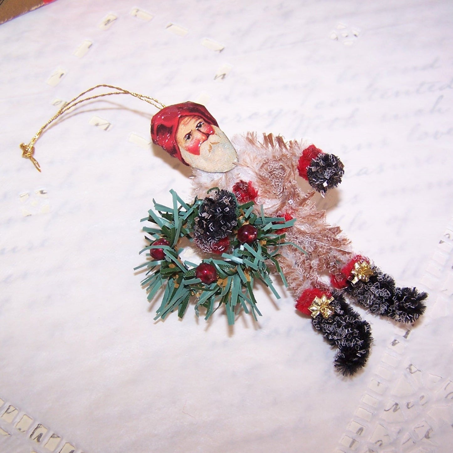Glittered Chenille Santa Claus Carrying Wreath Christmas Ornament