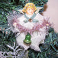 Of mixed materials, here's a small ALL OCCASION Guardian Angel decoration. The girl holds a pink tinsel garland from which a glass bell hangs.  One of a Kind!