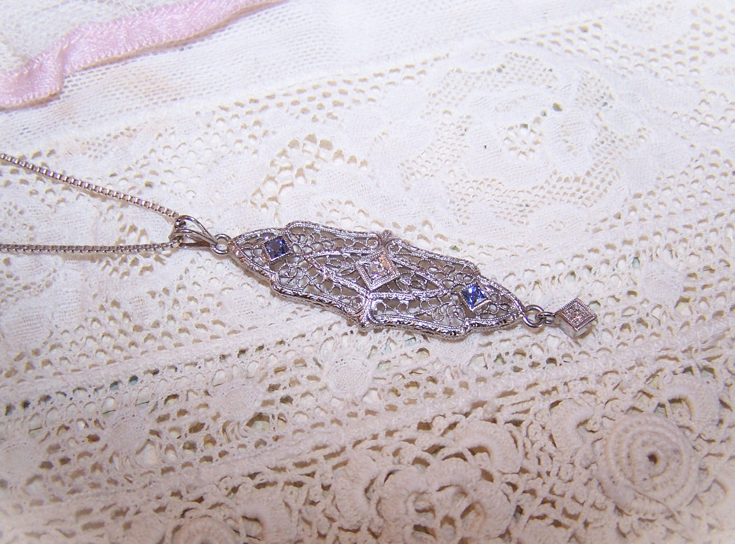 Antique Edwardian 14K White Gold filigree lavaliere pendant with 2 faceted round diamonds and 2 princess cut blue zircons or sapphires. 1-7/8" long x 7/16". 
