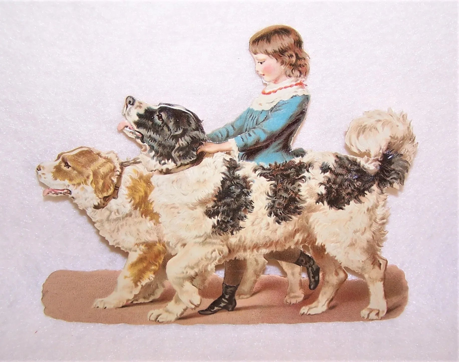 Large 6 inch antique victorian die cut of a young girl holding onto two dops - one blonde and white, the other black and white.  From an old scrapbook album.  No paper loss.  Glue residue on the reverse.