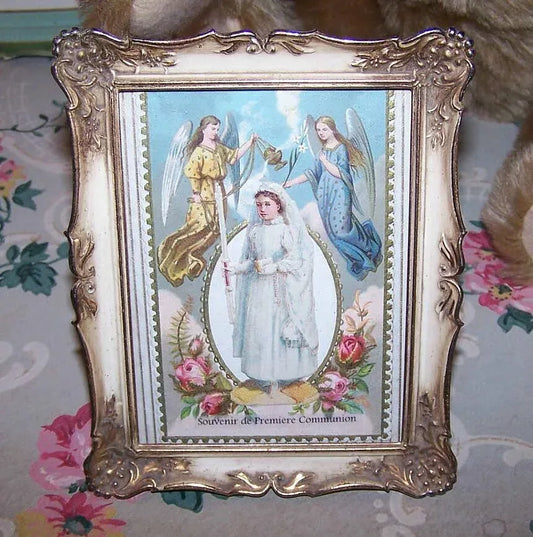 Souvenir of First Communion concoction.  A 4" x 5" metal frame, an Antique French religious card and Victorian Communiante (girl) die cut compose the piece.  