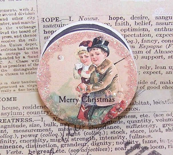 Antique French upcycled pharmacy box. The top displays the image of a Victorian couple walking; sentiment is MERRY CHRISTMAS. Perfect as a small gift box.