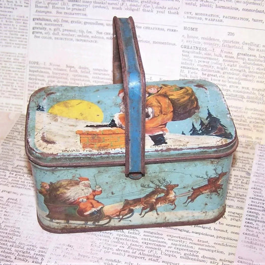 Art Deco lithographed tin Christmas box by Tindeco.  With handle, the box has Santa Claus graphics touching on the "Twas the Night Before Christmas" poem. 