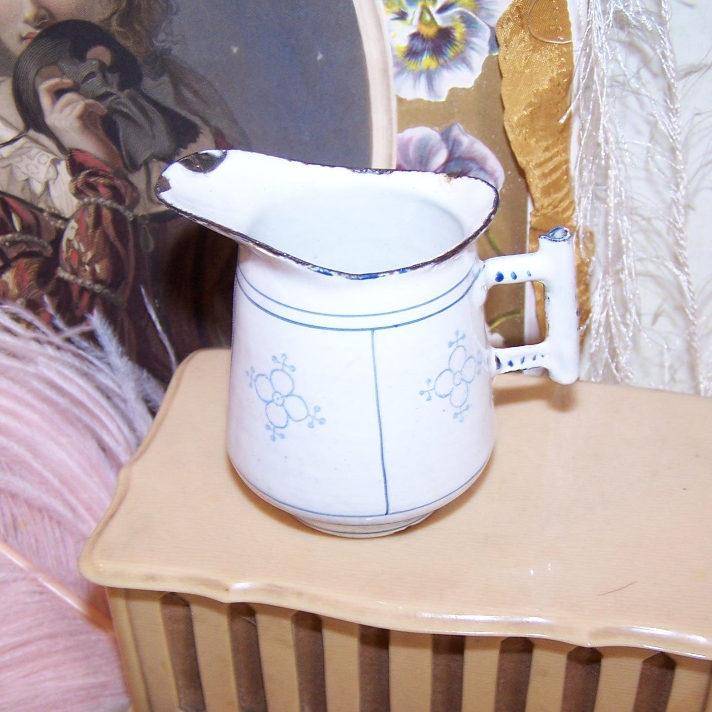 Circa 1910 blue & white enamelware toy pitcher from a child's tea set. Stands about 2-5/8" high; width is 2-3/4". Chippy here and there.