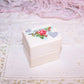 Cream paper ring box with slotted insert on the inside and Antique Victorian die cut reading WITH MY LOVE to the top.  1-1/2" high; base is 1-7/16" x 1-1/16"
