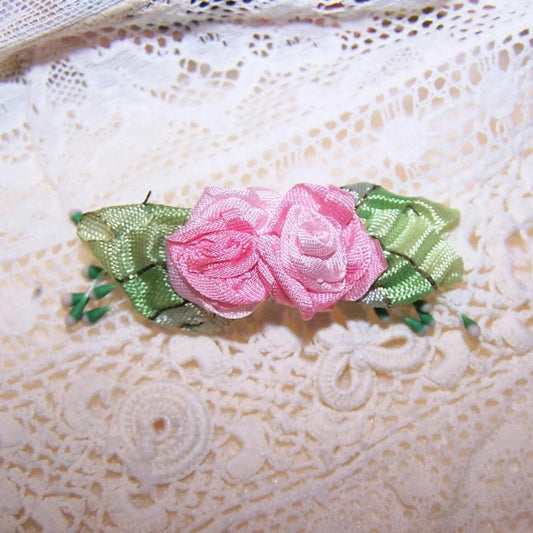 Antique French ribbonwork - a pair of pink ribbon flowers with green French striped ombre ribbon leaves. Further decoration of sugar pips.  1-3/4" x 9/16".