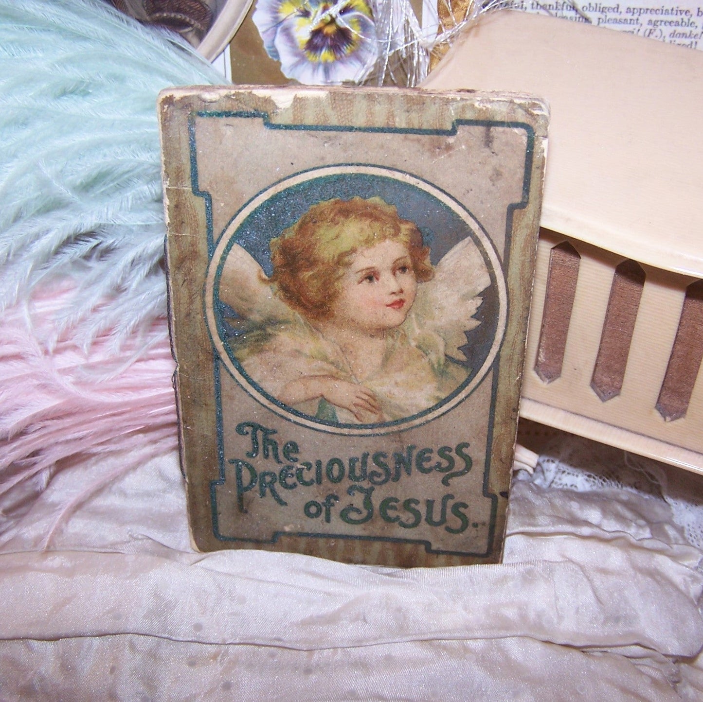 An antique booklet, printed in English and entitled "The Preciousness of Jesus".  Shabby appearance but the graphics are wonderful. Size is 4" x 2-1/2" approx. 